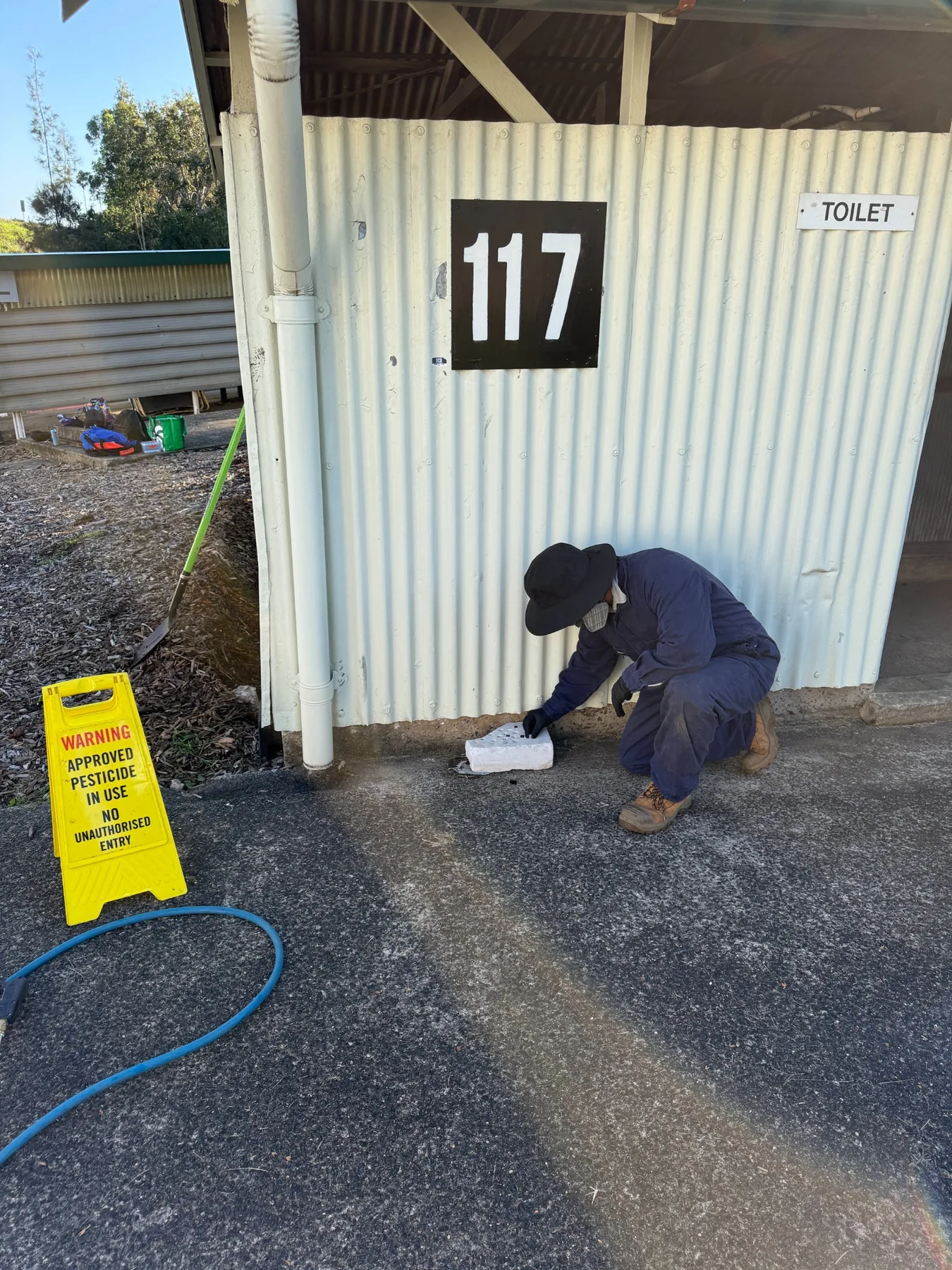 Goliath Pest Solutions technician applying treatment at a Sydney property